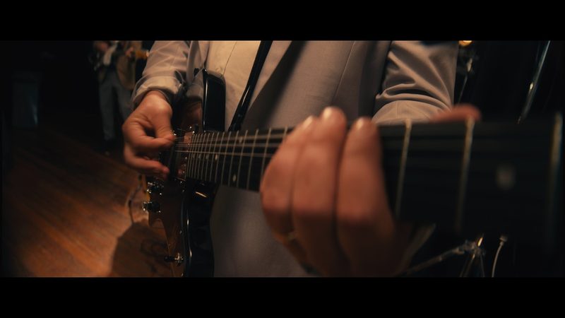 Close-up of a guitar in GRUB’s official “Shake It” video