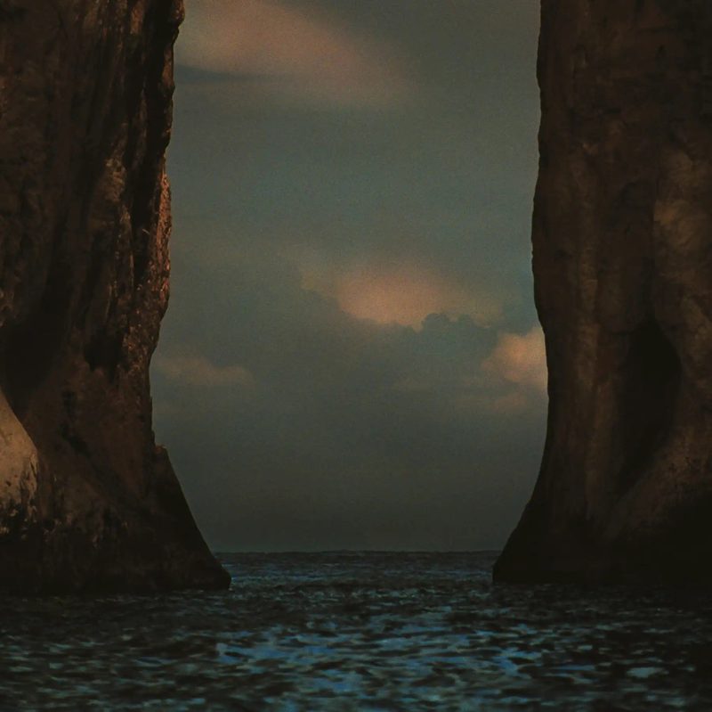 Cover of M83’s I Wrote You a Letter, showing the sea between two rock walls