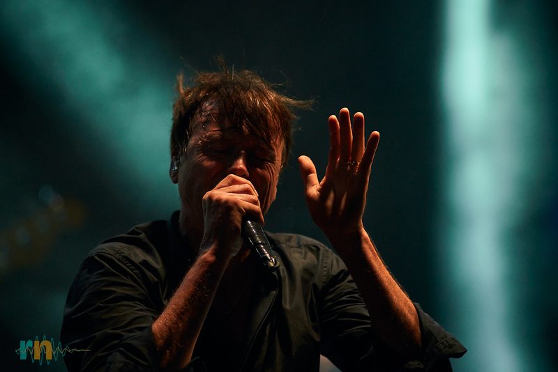 Brett Anderson singing under the spotlight in Mamba Garden