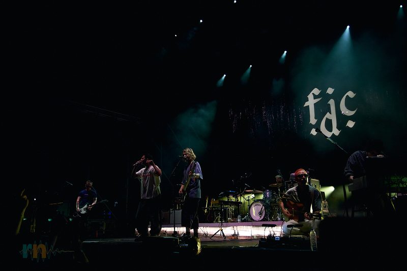 The full Fontaines D.C. band performs amid haze and white spotlights at El Muelle Live in Alicante, Spain.